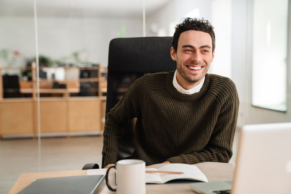 happyworker Man working on EOS company accounting at his desk