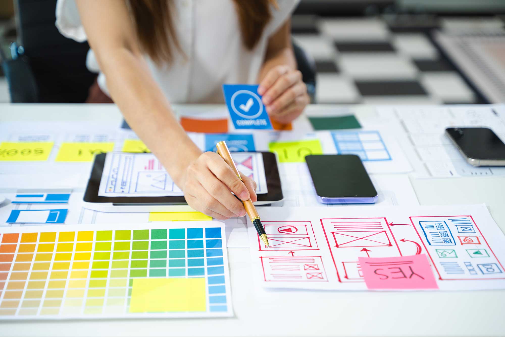 SaaS developer pointing at wireframe and charts